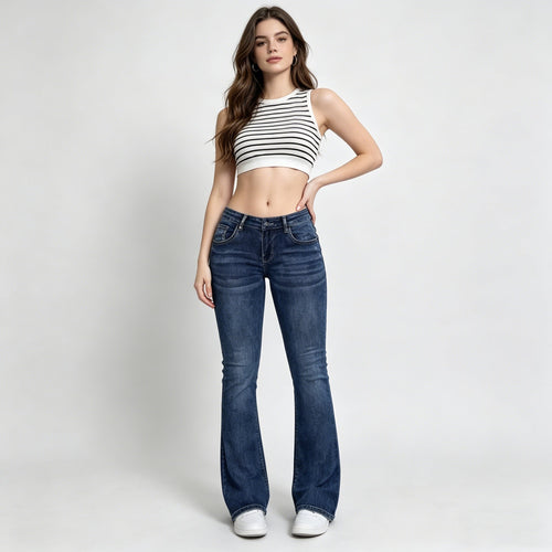 Woman wearing a striped crop top and blue jeans on a white background