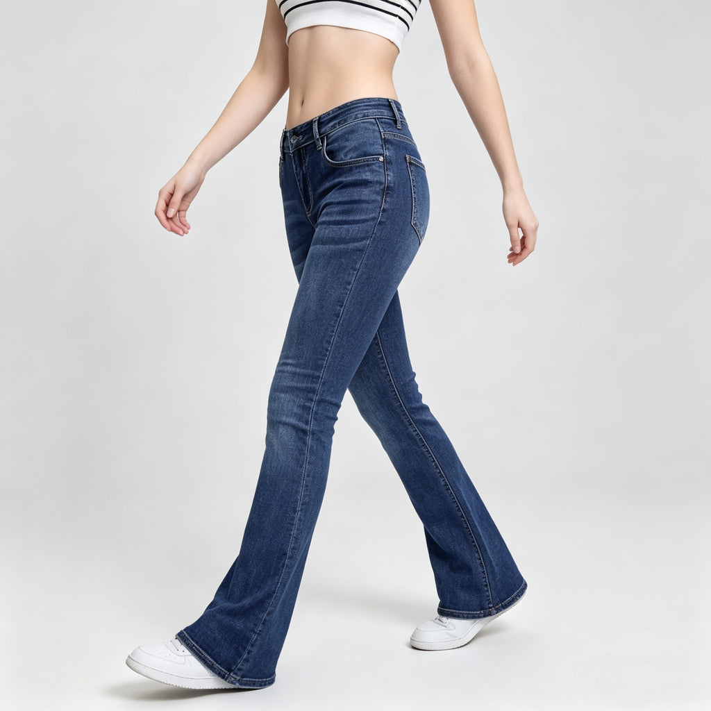Person wearing blue flared jeans on a white background