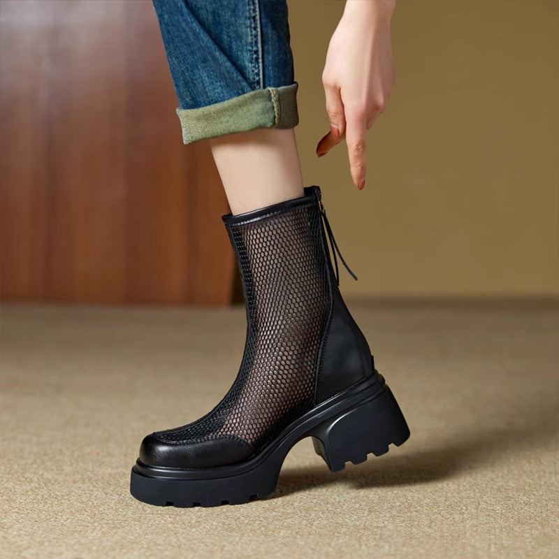 Black mesh boot with a chunky sole worn by a person, on a neutral background