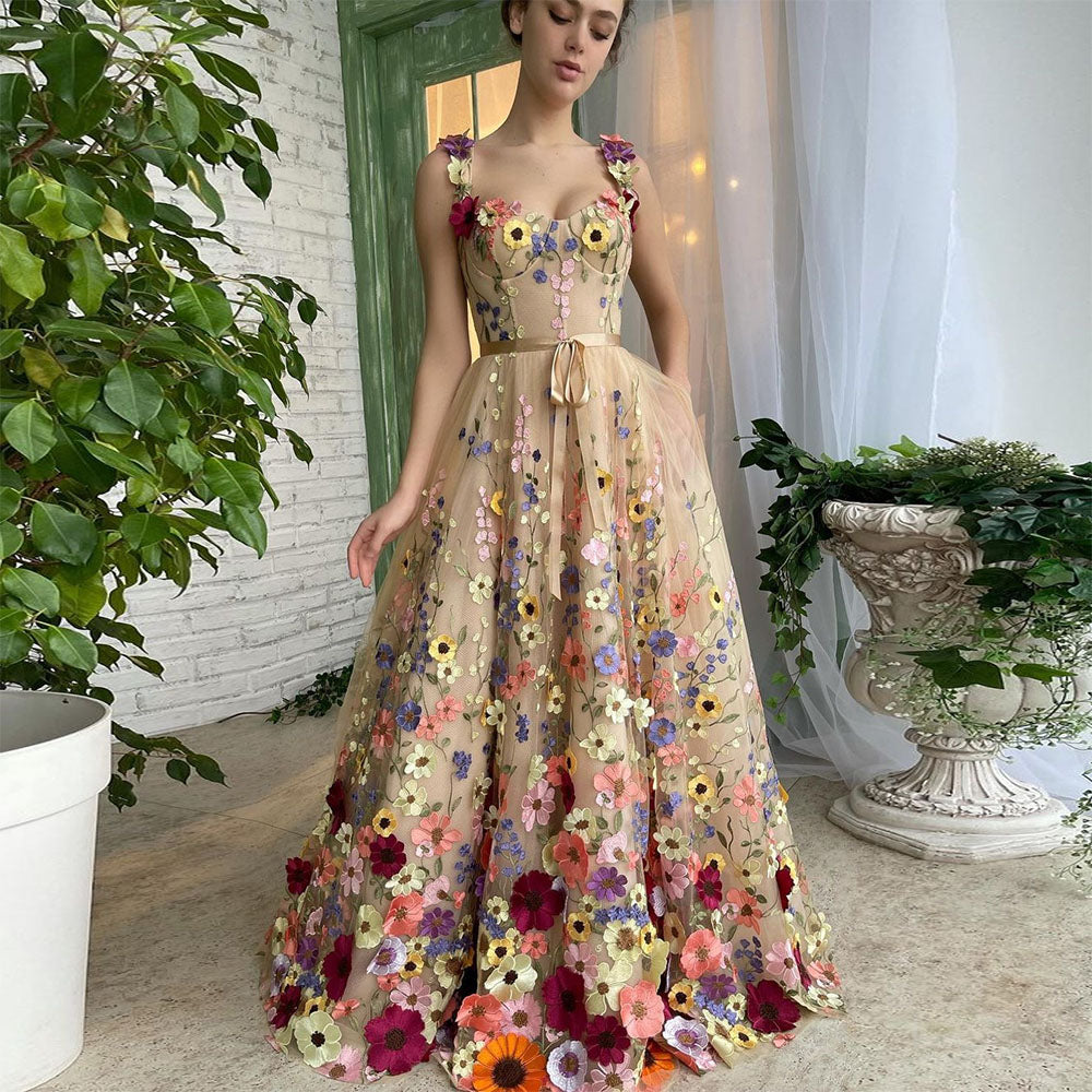 Woman wearing a floral dress in an indoor setting with plants.