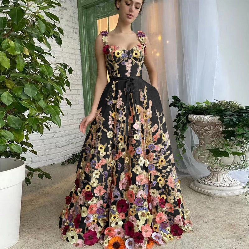 Woman wearing a floral dress standing indoors with decorative elements.