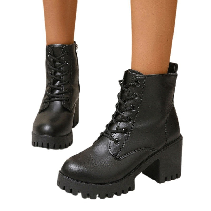Black leather boots with chunky heels on a white background
