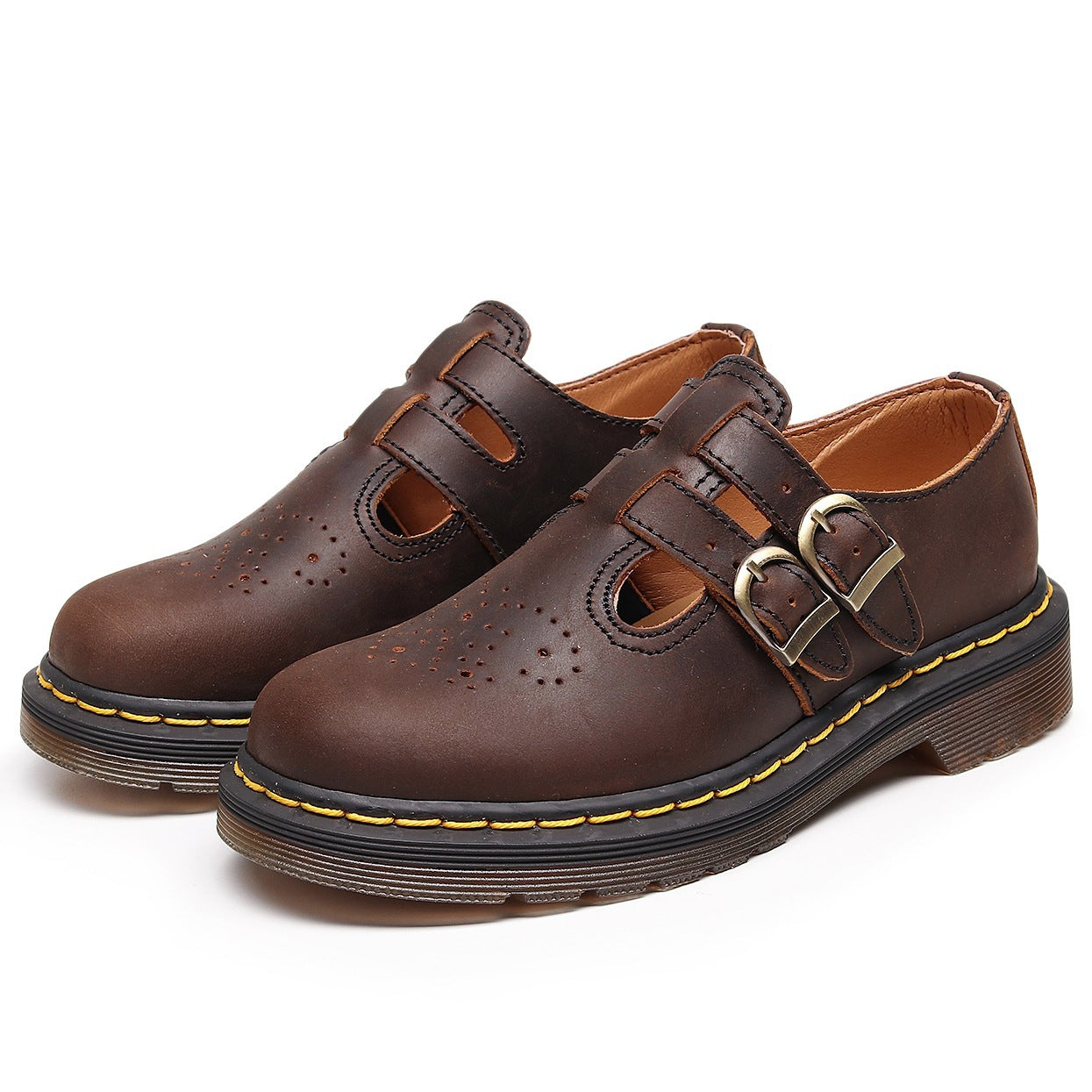 Pair of brown leather shoes with buckles on a white background
