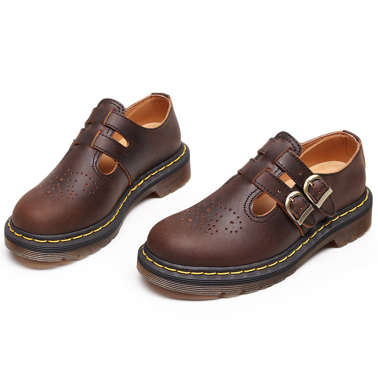 Pair of brown leather shoes with buckles on a white background