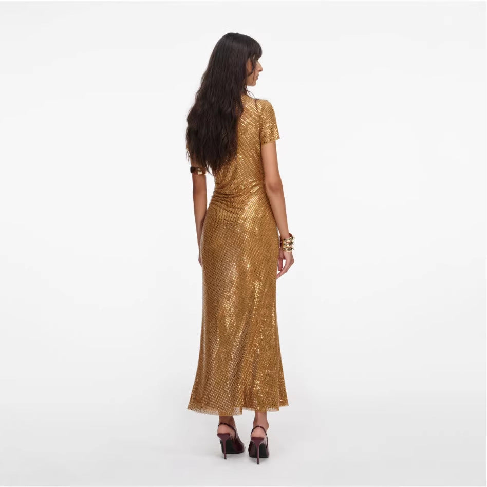 Woman wearing a gold sequin dress on a white background