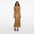 Woman wearing a gold sequin dress on a white background