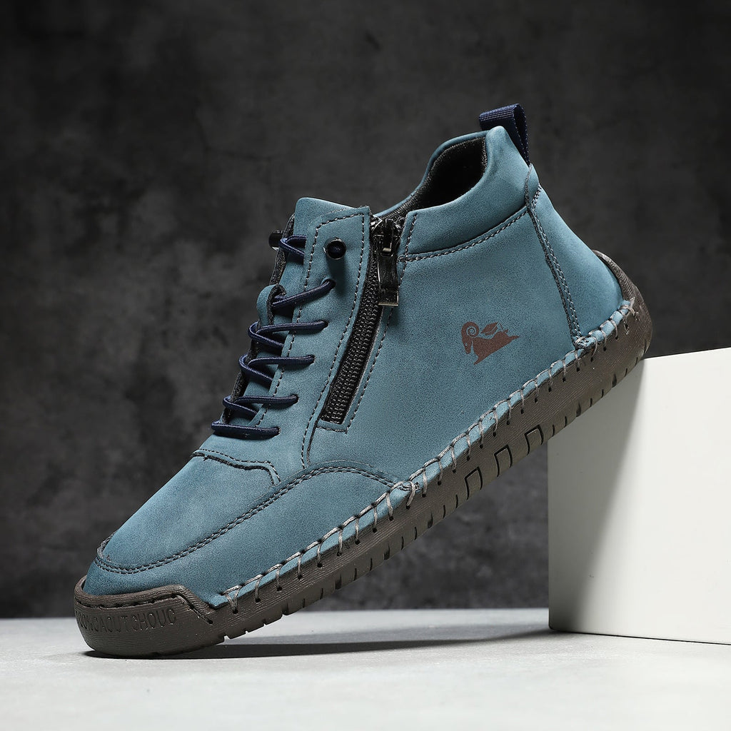 Blue leather shoe with a brown sole on a dark background