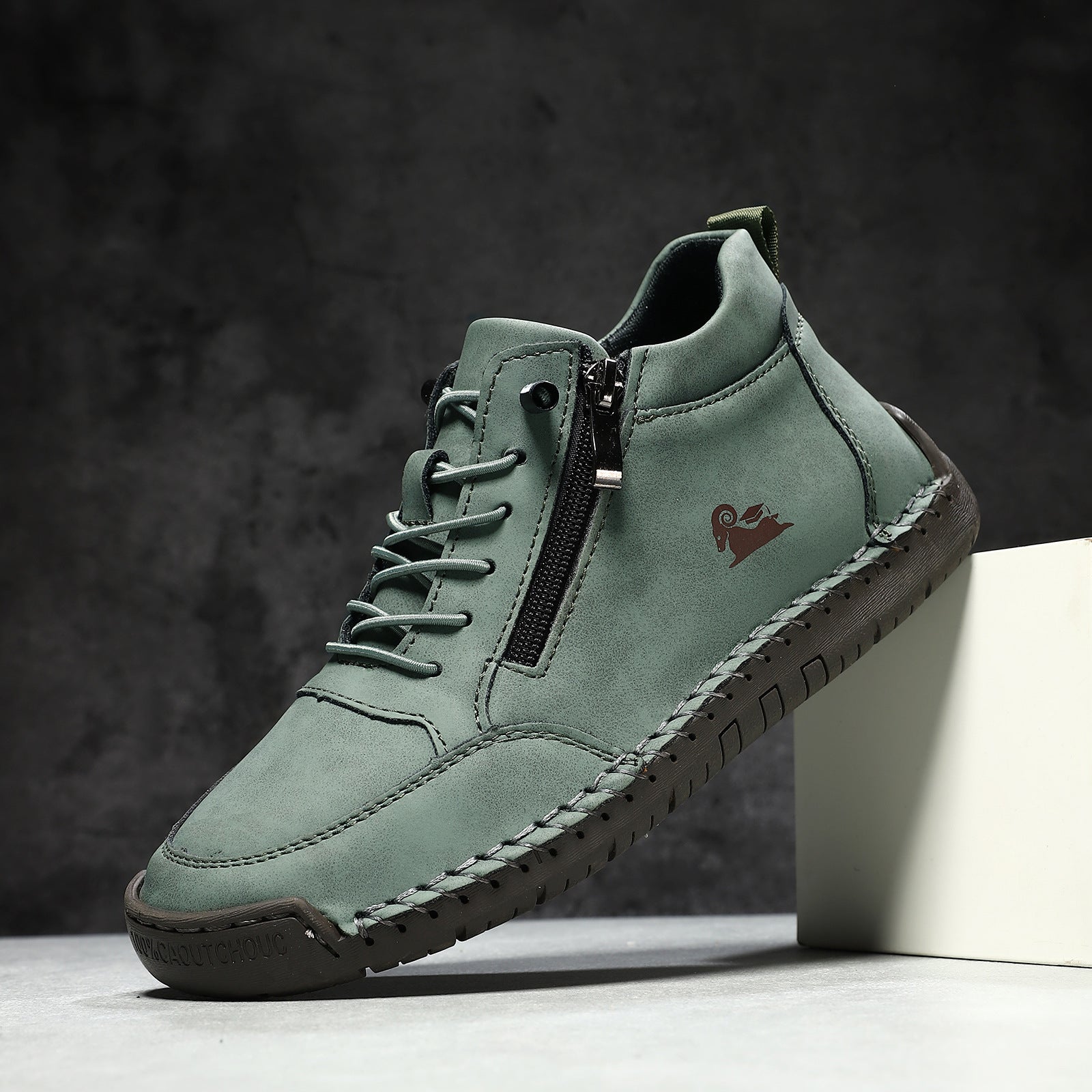 Green leather shoe with a zipper on a dark background