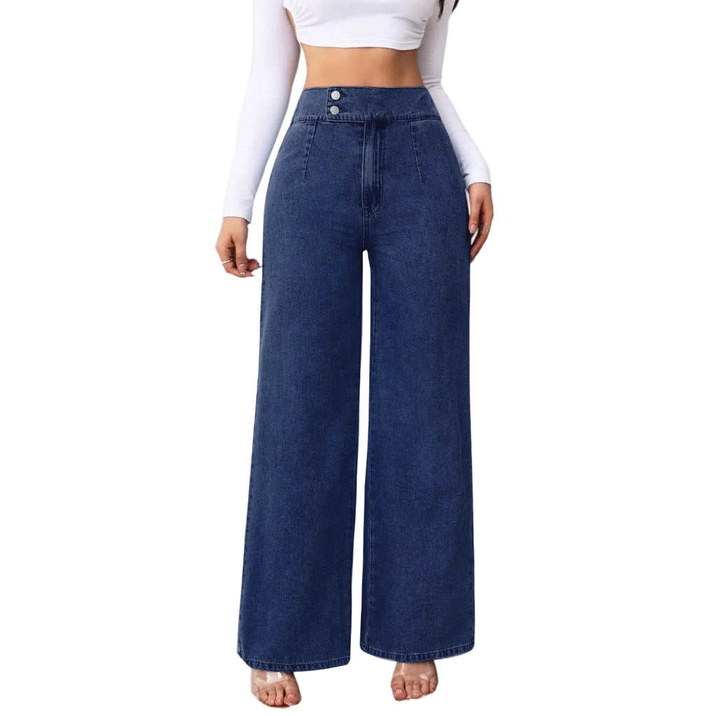 Person wearing blue wide-leg jeans on a plain background