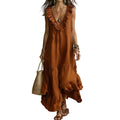 Woman wearing a rust-colored dress with ruffled details, holding a straw bag against a neutral background.