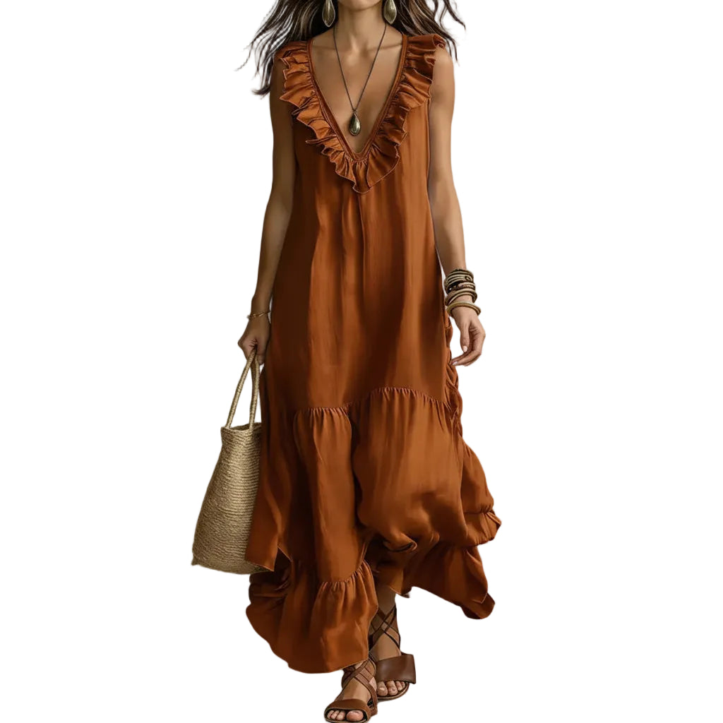 Woman wearing a rust-colored dress with ruffled details, holding a straw bag against a neutral background.