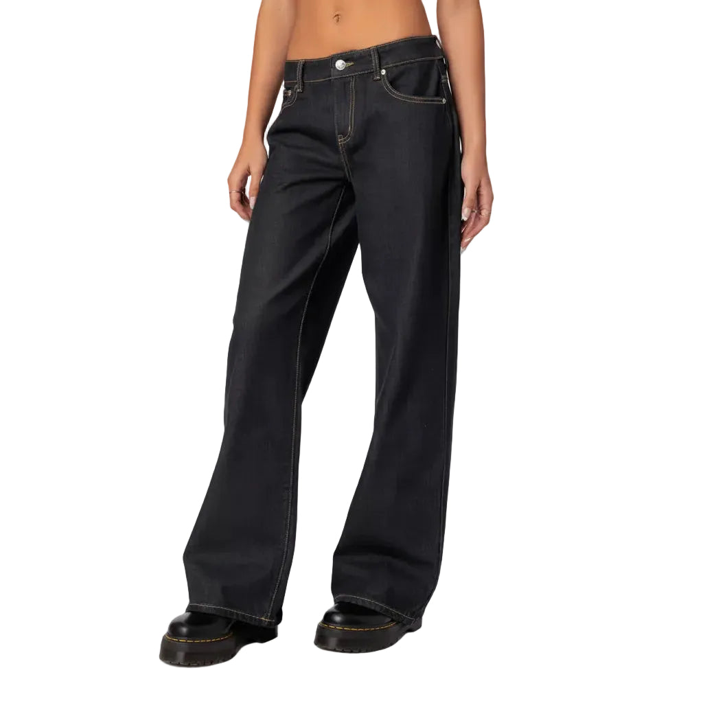 Person wearing black jeans on a white background