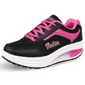 Black and pink running shoe with white sole on a white background