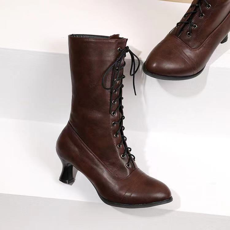 Brown lace-up boots on a white background