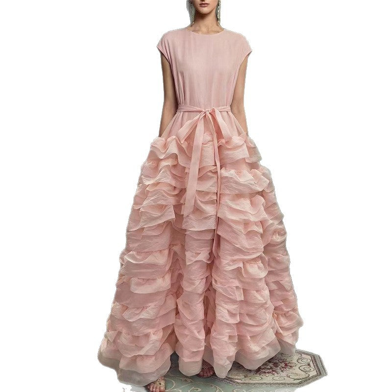 Pink ruffled gown on a white background