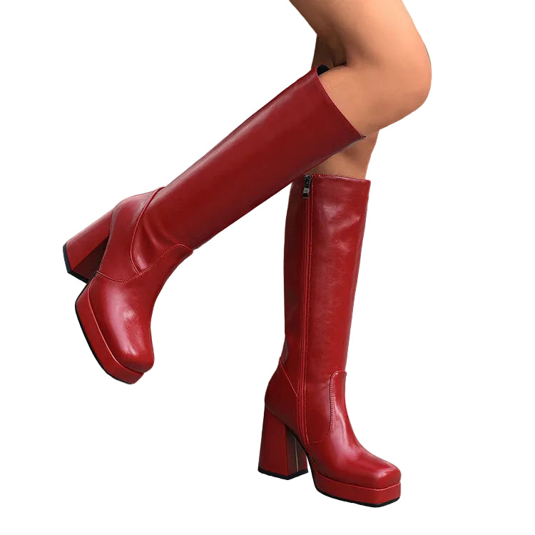 Red knee-high boots on a blurred street background