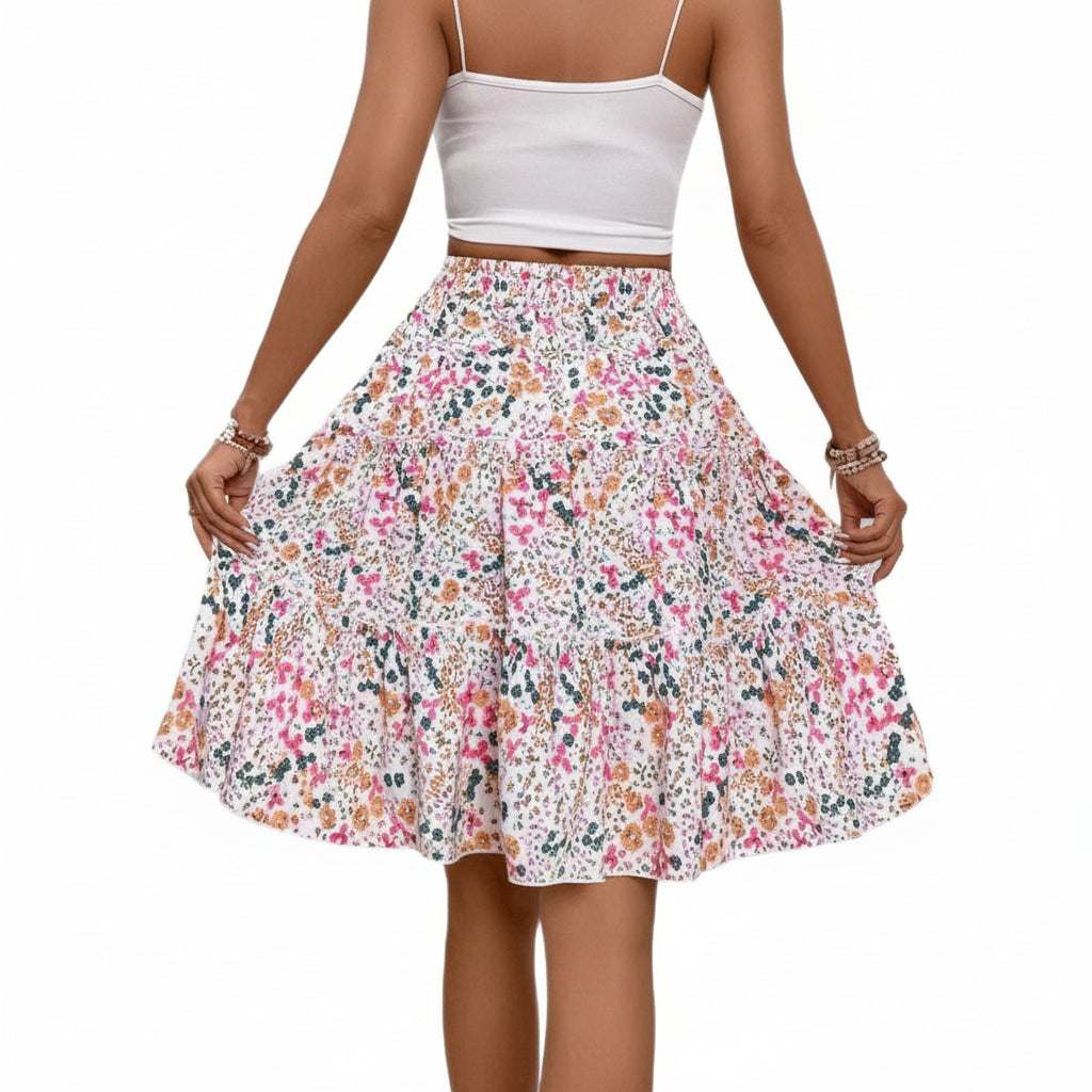 Woman wearing a floral skirt and white top on a white background