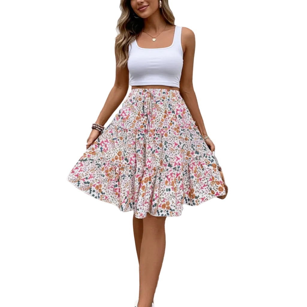 Person wearing a floral skirt with a white wall background