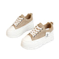 Beige sneakers with white soles on a gray background