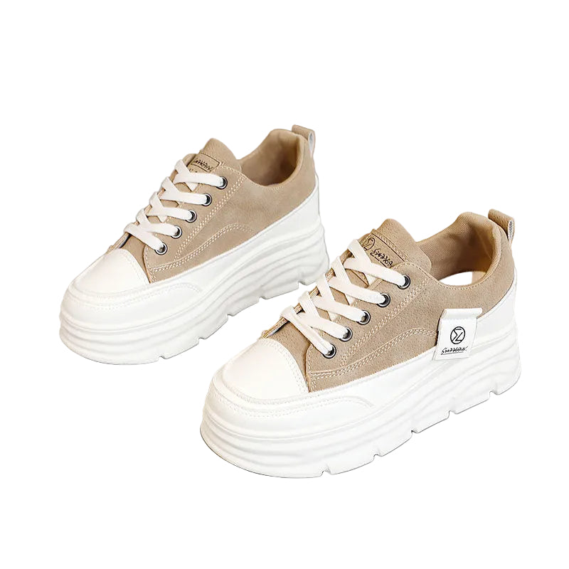 Beige sneakers with white soles on a gray background