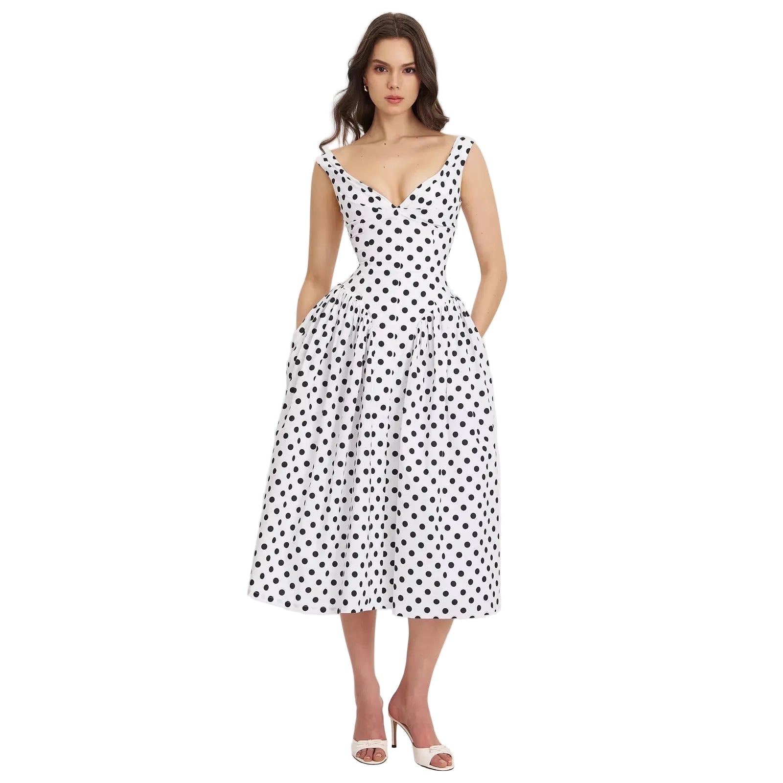 Woman wearing a black and white polka dot dress on a light gray background