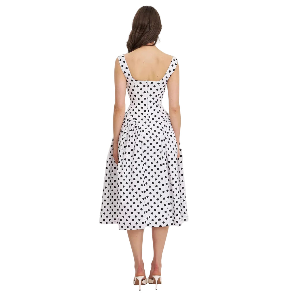 Woman wearing a polka dot dress on a white background