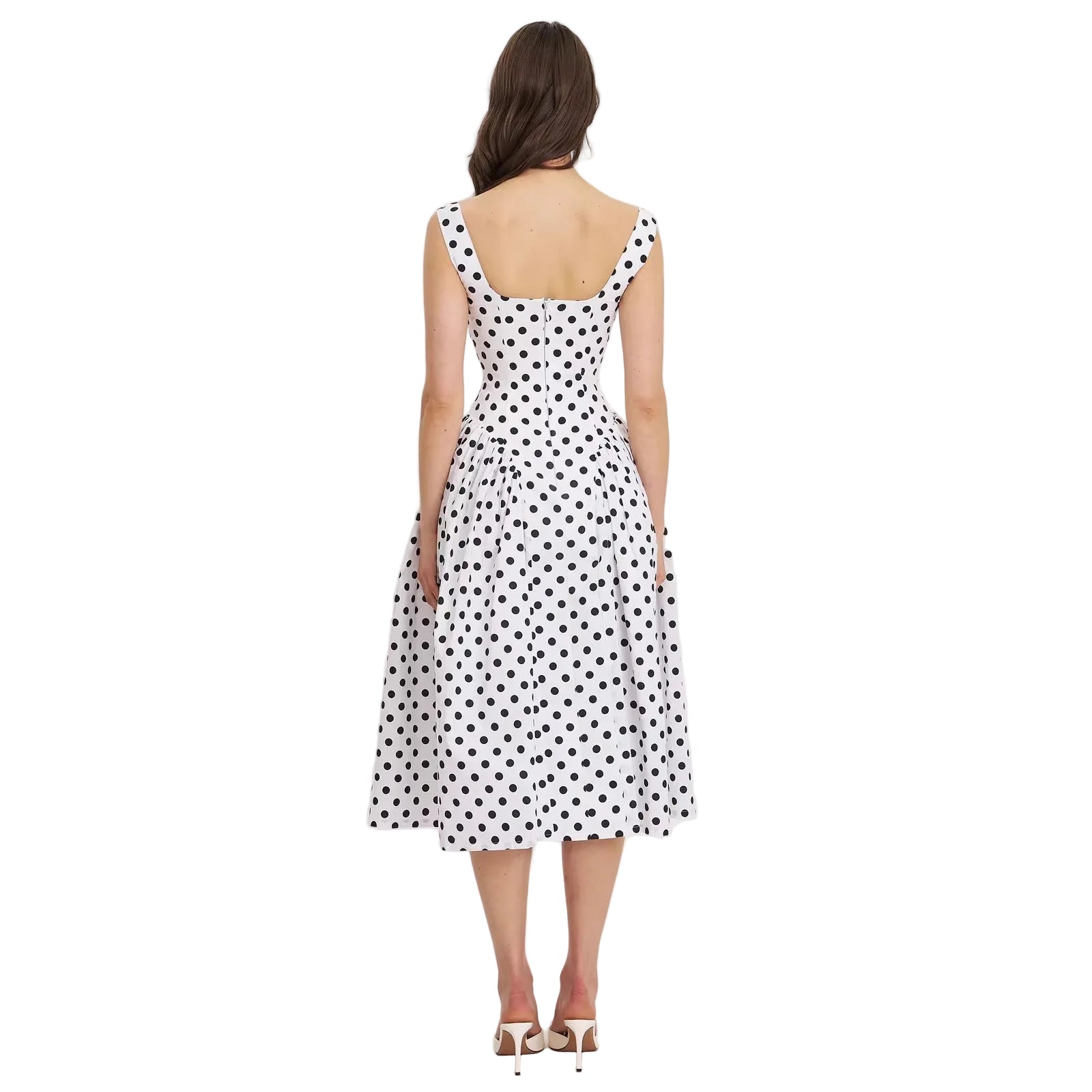 Woman wearing a polka dot dress on a white background