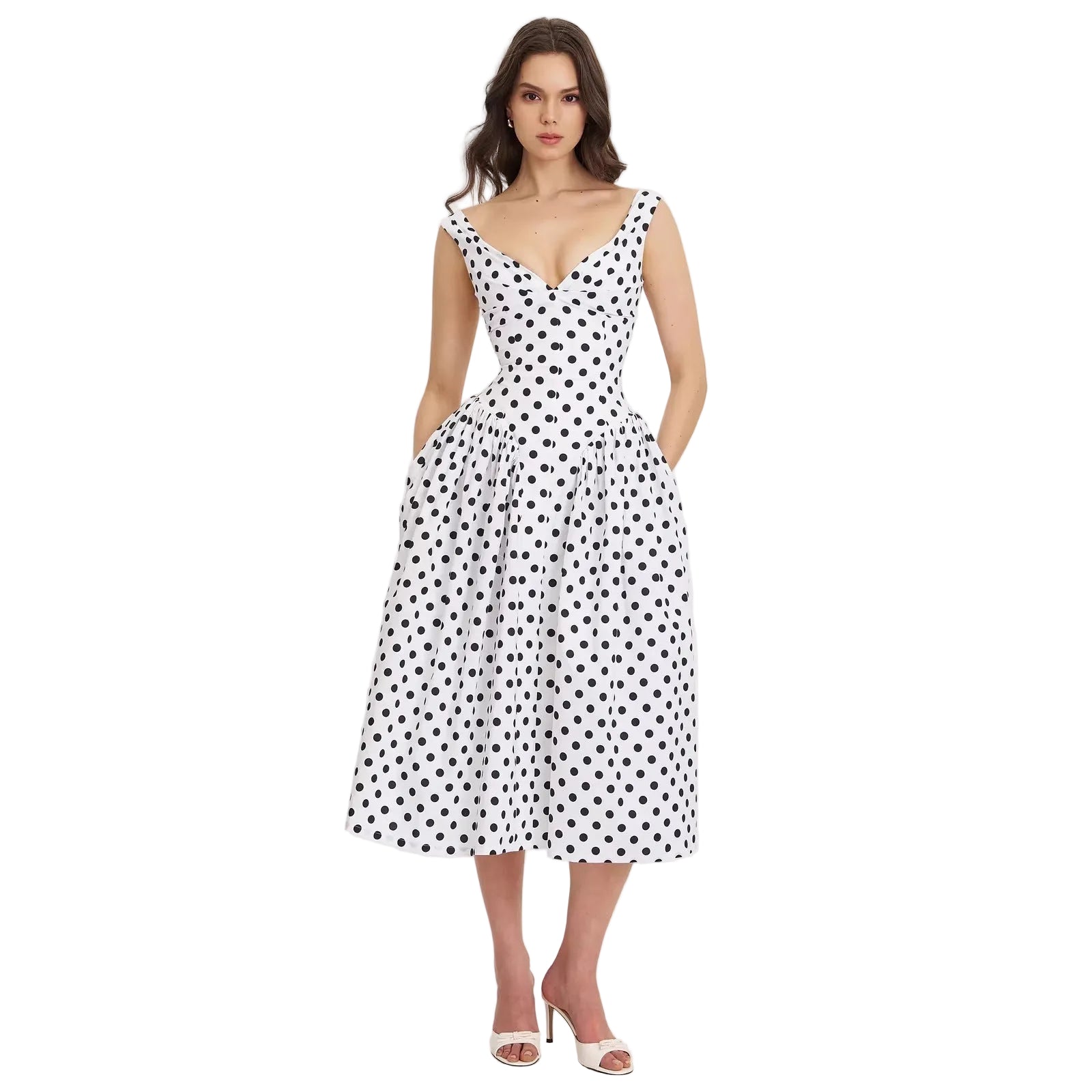 Woman wearing a black and white polka dot dress on a light gray background